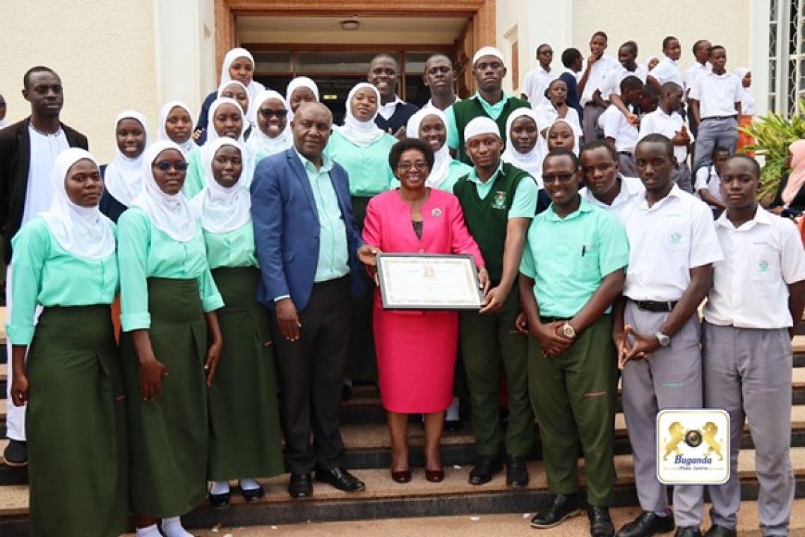 Hon. Clotilda Nakate Kikomeko presents certificate to the principal and students of Gombe SS, honouring their commitment to the Kingdom Hon. Clotilda Nakate Kikomeko presents certificate to the principal and students of Gombe SS, honouring their commitment to the Kingdom